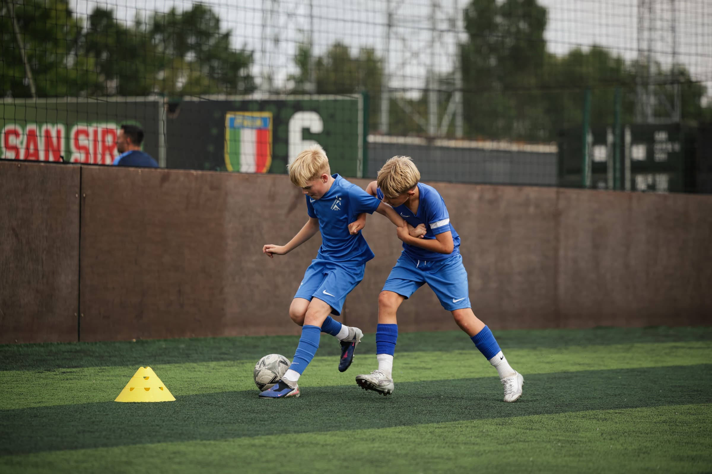 Two SG Elite players shielding and challenging for the ball in training at Goals Wimbledon